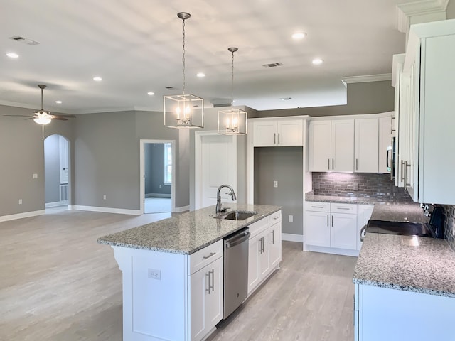 kitchen featuring sink, stainless steel appliances, white cabinets, and a kitchen island with sink