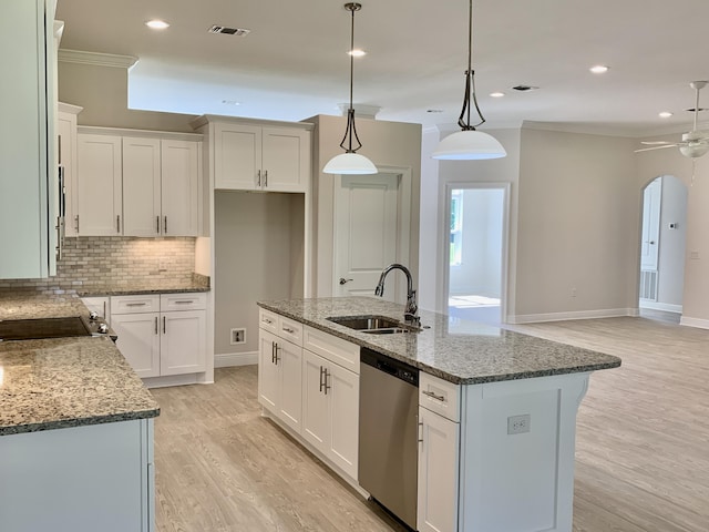 kitchen featuring dishwasher, pendant lighting, a kitchen island, white cabinets, and sink