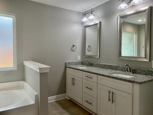 bathroom with a bathing tub and vanity