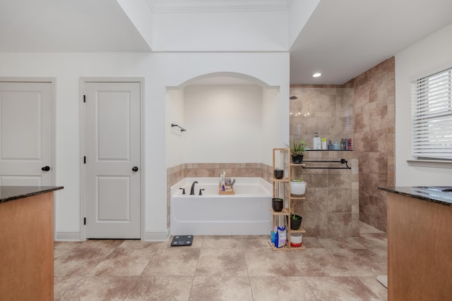 bathroom with crown molding and shower with separate bathtub