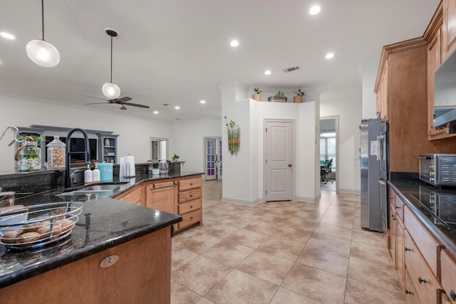 kitchen with visible vents, a toaster, recessed lighting, freestanding refrigerator, and a sink