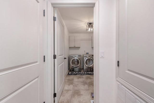 washroom with cabinet space and independent washer and dryer