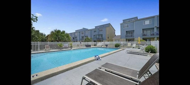 view of swimming pool featuring a patio area