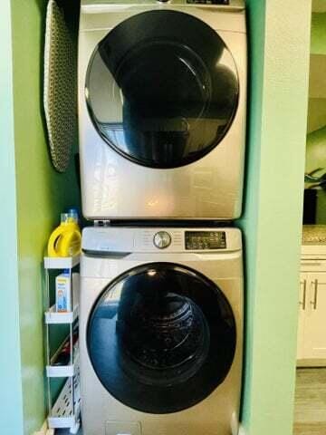 laundry area featuring stacked washing maching and dryer