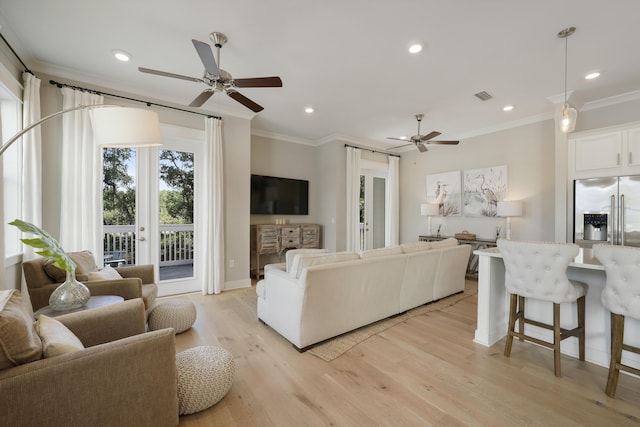 living room with ceiling fan, crown molding, and light hardwood / wood-style floors