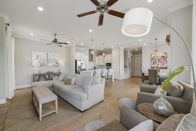 living room featuring light wood-type flooring, ceiling fan, and crown molding