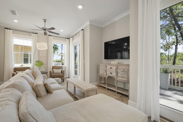 living room with ceiling fan, wood-type flooring, and ornamental molding