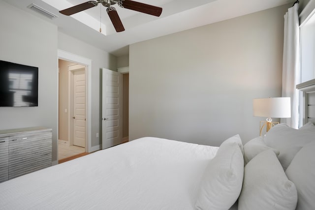 bedroom with ceiling fan and connected bathroom