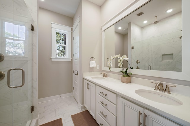 bathroom with walk in shower and vanity