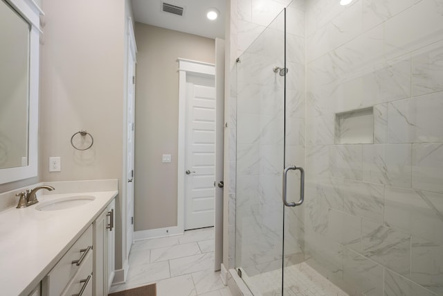 bathroom with an enclosed shower and vanity