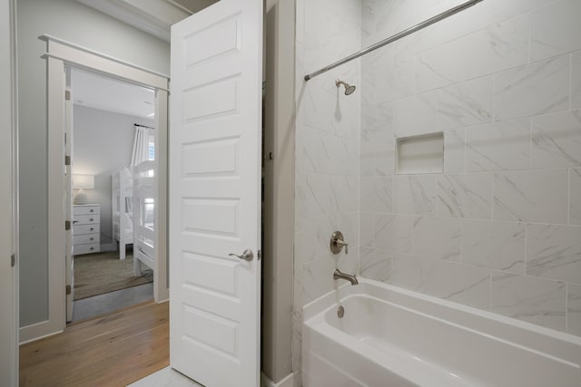 bathroom featuring tiled shower / bath and hardwood / wood-style floors