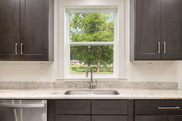 kitchen featuring sink, dark brown cabinets, dishwasher, and plenty of natural light