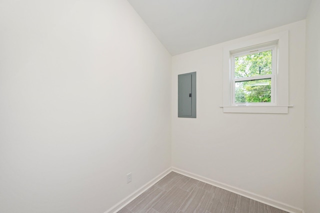 empty room featuring electric panel and lofted ceiling