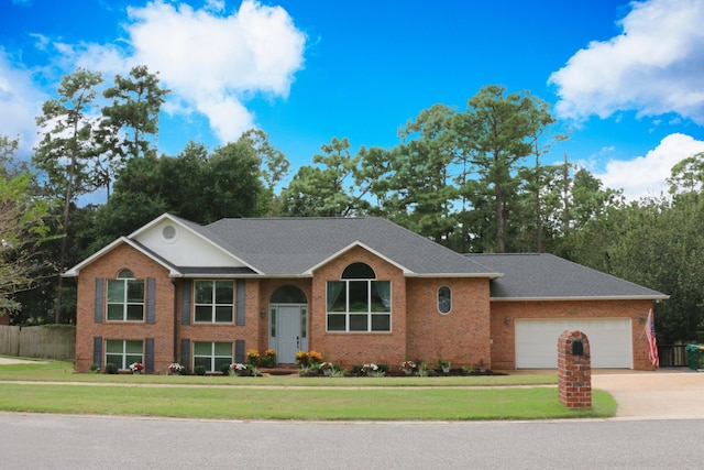 view of front of home with a garage and a front lawn