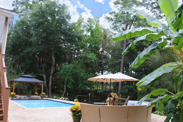 view of pool featuring a gazebo, a playground, and a patio area