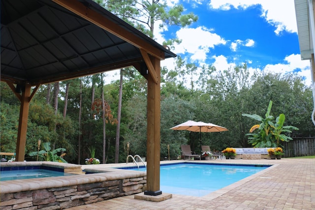 view of pool featuring a hot tub and a patio