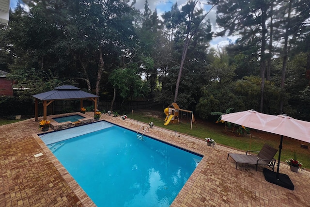 view of pool featuring a gazebo, a patio, a playground, and an in ground hot tub