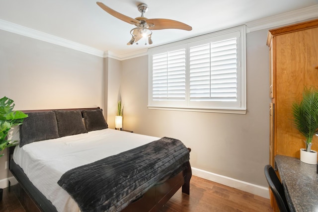 bedroom with dark wood-type flooring, ceiling fan, and crown molding