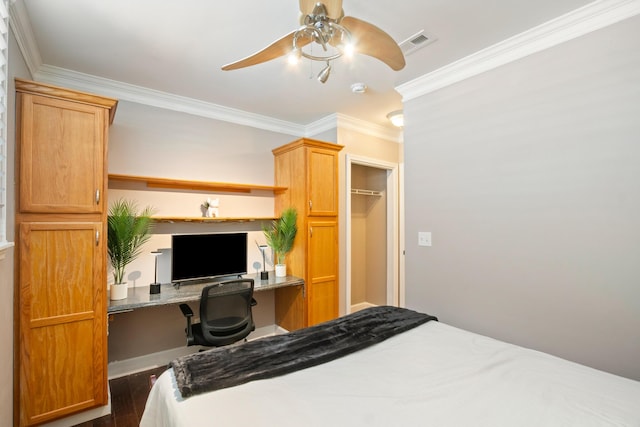 bedroom featuring crown molding, built in desk, dark hardwood / wood-style floors, and ceiling fan