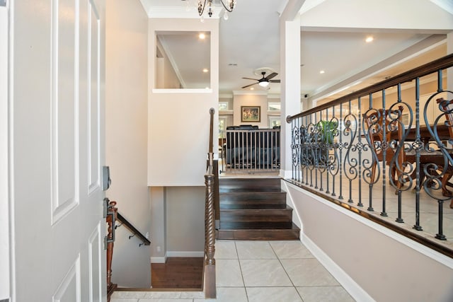 stairway featuring ornamental molding, tile patterned floors, and ceiling fan