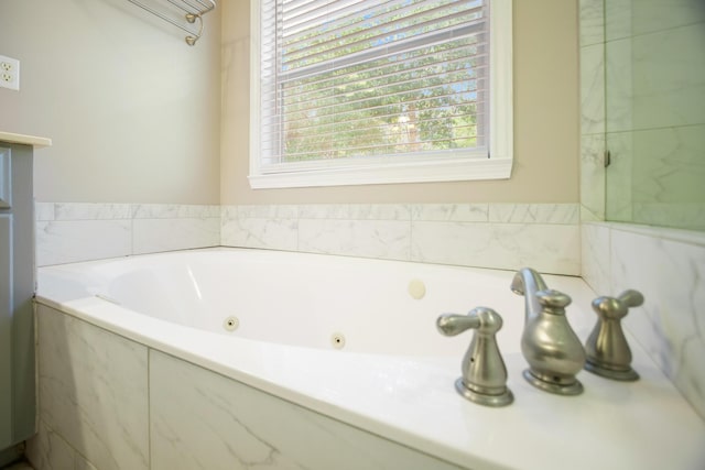 bathroom featuring a relaxing tiled tub