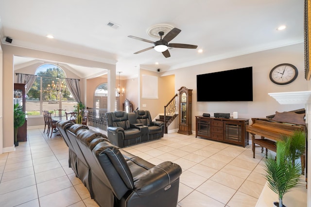 tiled living room featuring crown molding and ceiling fan with notable chandelier