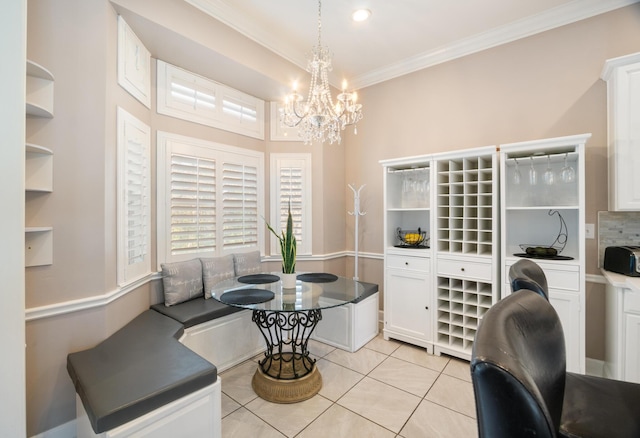 dining room with breakfast area, a notable chandelier, ornamental molding, and light tile patterned floors