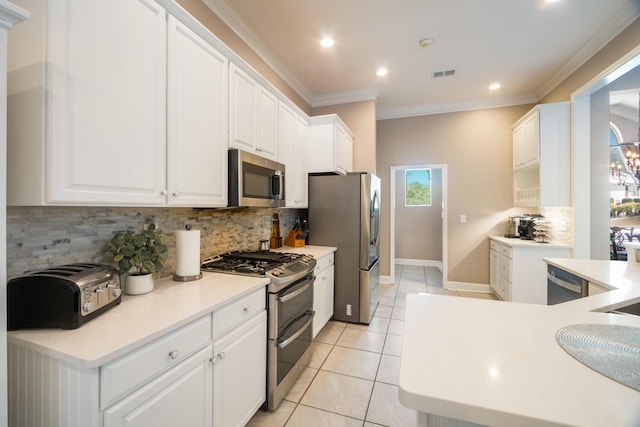 kitchen featuring light tile patterned floors, appliances with stainless steel finishes, ornamental molding, white cabinets, and decorative backsplash