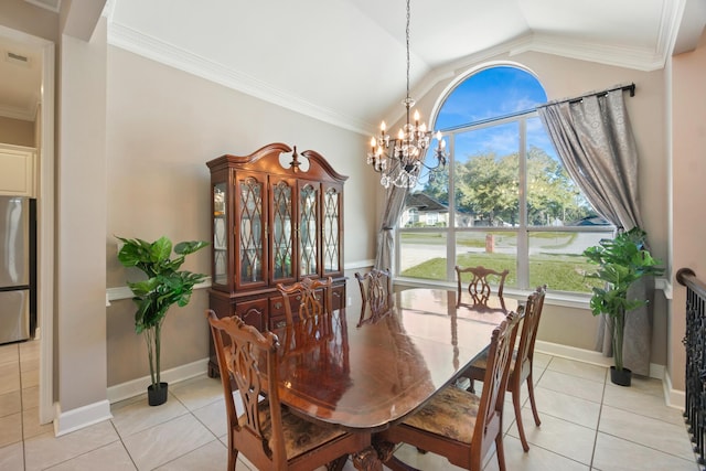 tiled dining area with a notable chandelier, vaulted ceiling, and ornamental molding