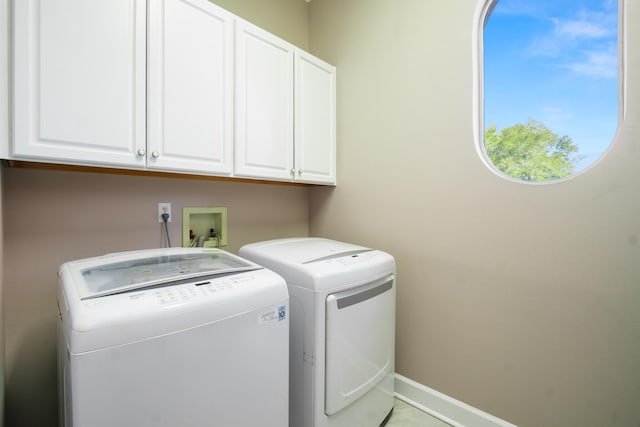 laundry room with cabinets and washer and clothes dryer