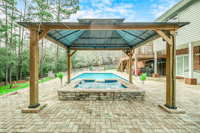 view of pool with a gazebo, a patio area, and an in ground hot tub