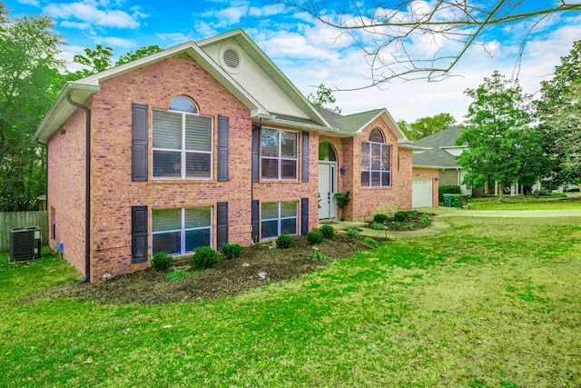 view of front of property with central AC unit and a front yard