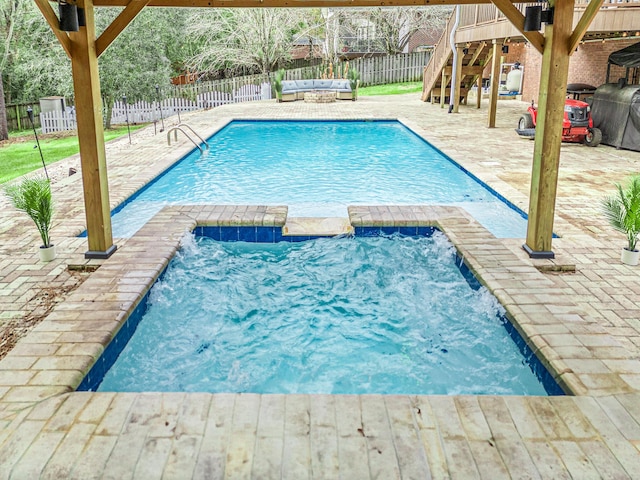 view of pool with a patio and pool water feature