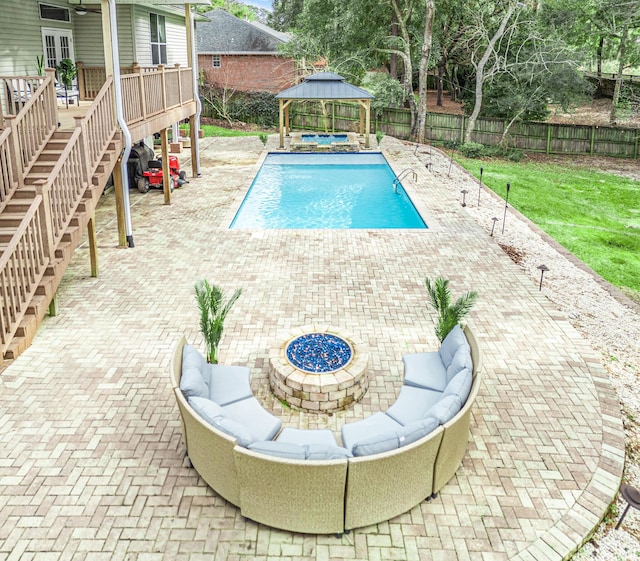 view of swimming pool featuring a gazebo, a patio, and a fire pit