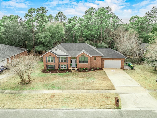 ranch-style home featuring a garage and a front lawn