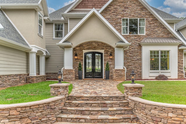 doorway to property featuring a lawn and french doors