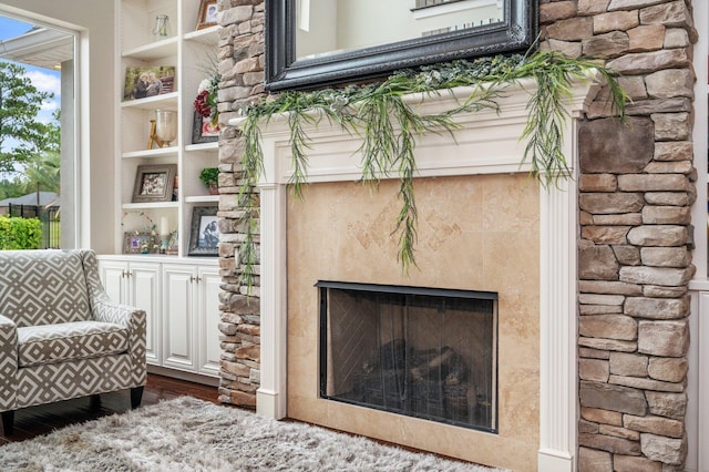 living area with a fireplace and built in features