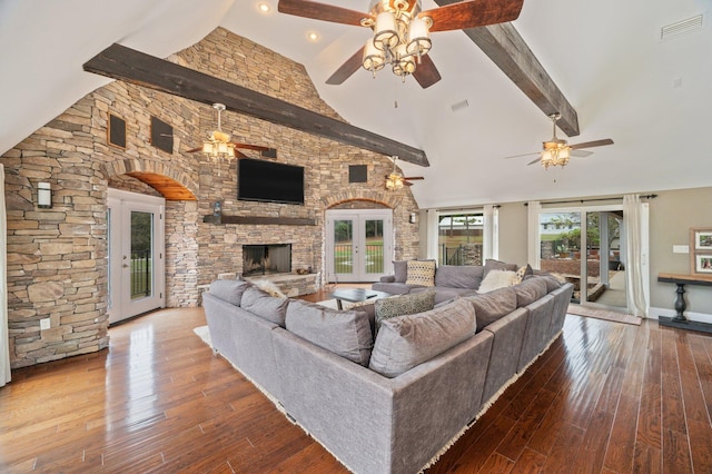 living room with french doors, beamed ceiling, high vaulted ceiling, a fireplace, and wood-type flooring