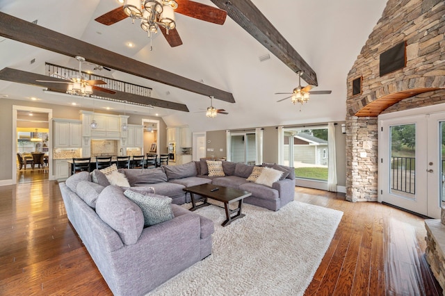 living room with light wood-type flooring, beamed ceiling, ceiling fan, french doors, and high vaulted ceiling