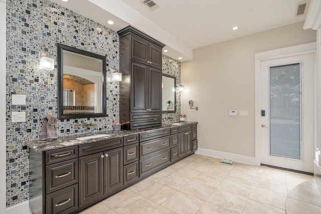 bathroom with backsplash, tile patterned floors, and vanity