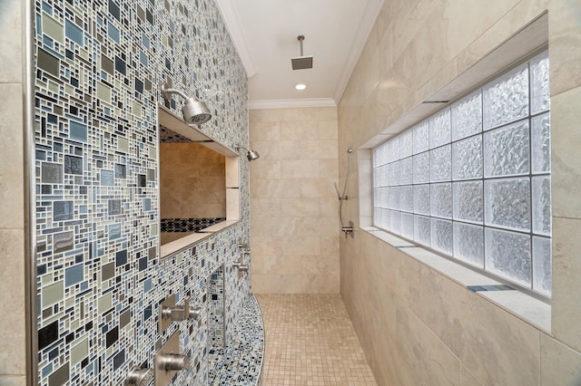 bathroom featuring ornamental molding, tiled shower, and tile walls