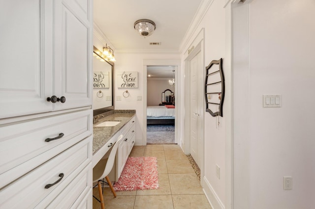 bathroom featuring vanity, tile patterned flooring, and ornamental molding