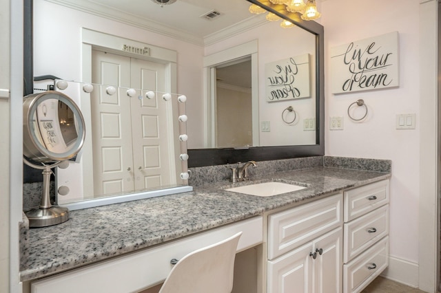 bathroom featuring crown molding and vanity