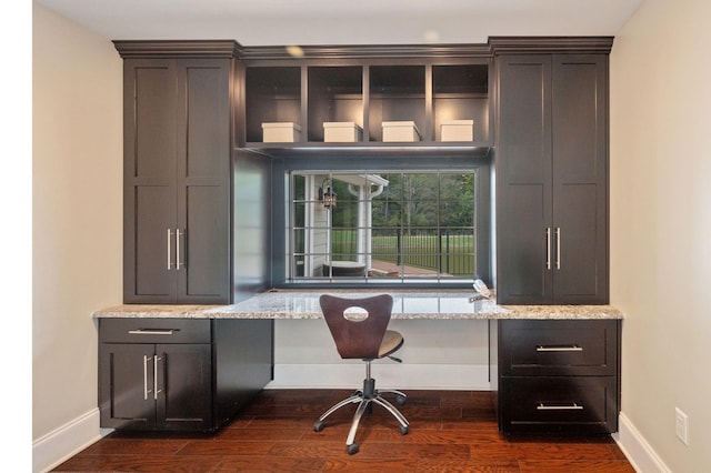 office space featuring built in desk and dark hardwood / wood-style floors