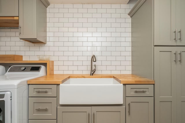 washroom featuring cabinets, separate washer and dryer, and sink