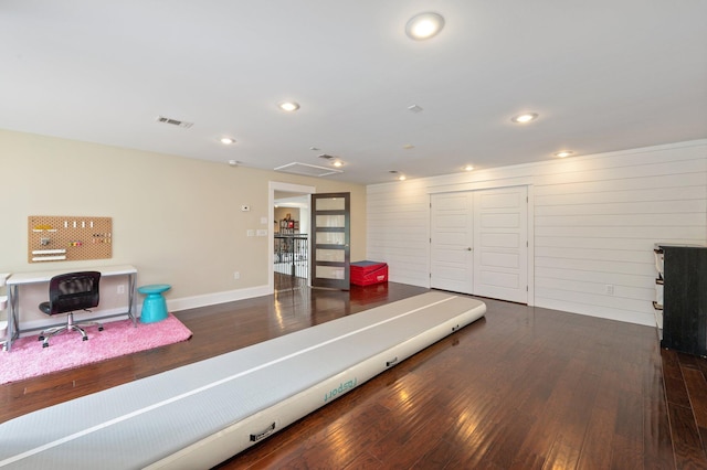 workout area with dark hardwood / wood-style flooring