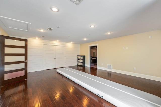 workout room with dark hardwood / wood-style flooring