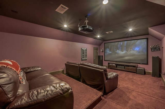 cinema with lofted ceiling and carpet flooring