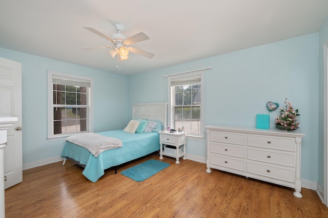 bedroom featuring ceiling fan and light hardwood / wood-style flooring