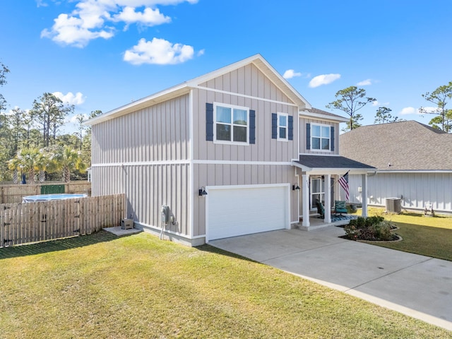 view of front of home with a garage, fence, driveway, board and batten siding, and a front yard